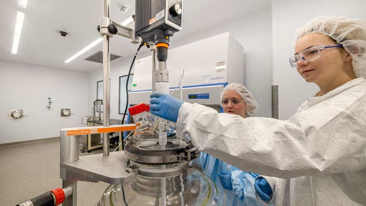 Aldevron mRNA associates preparing equipment for manufacturing